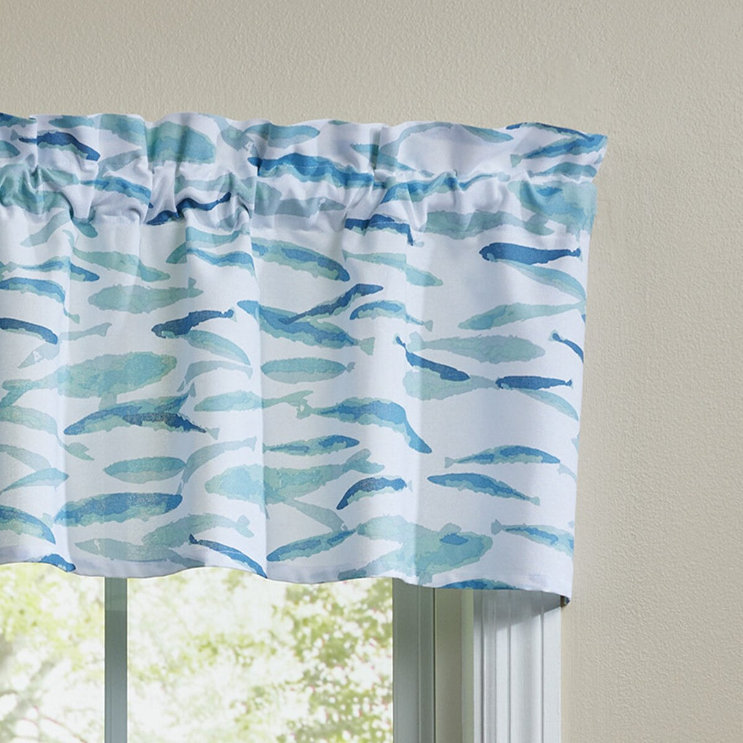 Window valance with blue fish pattern on a beige background