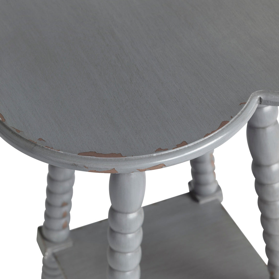 Round gray table with worn surface on a white background