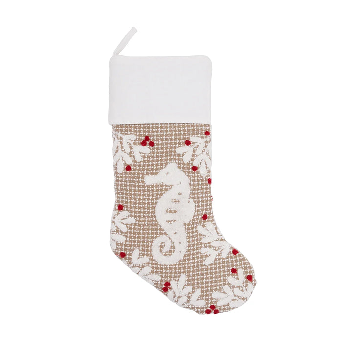 Coastal seahorse Christmas stocking with a white cuff, textured beige fabric, and red berry accents on a white background