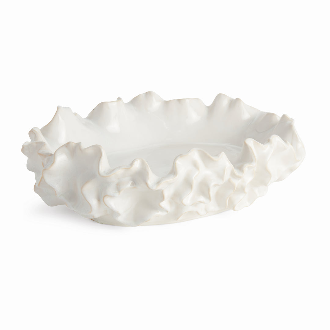 White ceramic bowl with a sea-life inspired ruffled edge on a white background