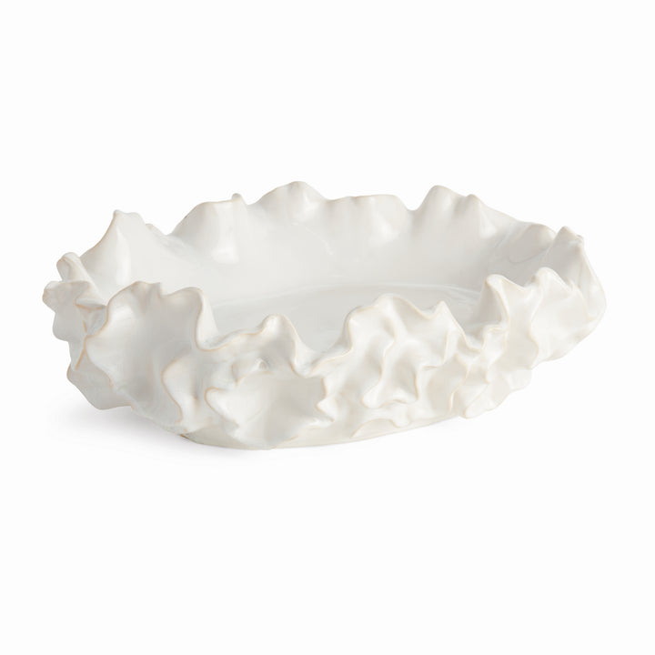 White ceramic bowl with a sea-life inspired ruffled edge on a white background