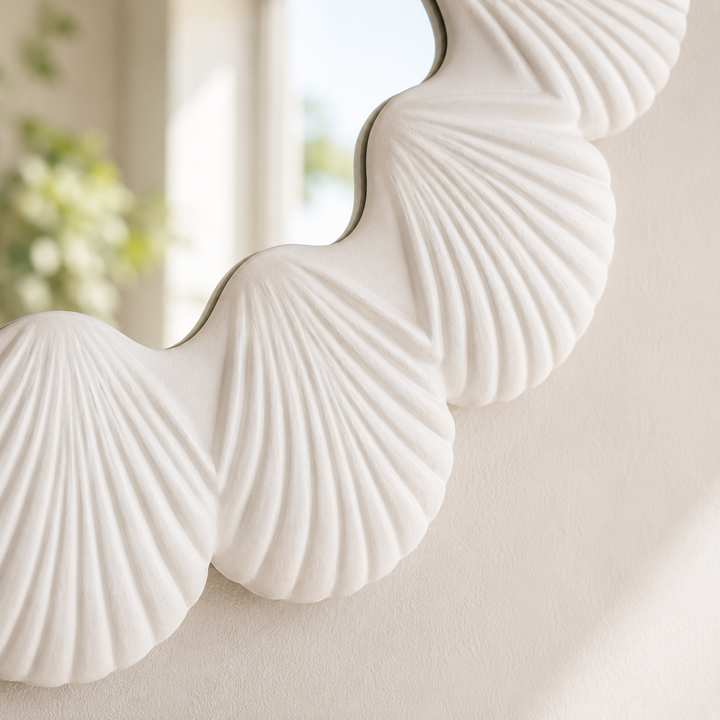 Decorative mirror with shell design on a neutral background