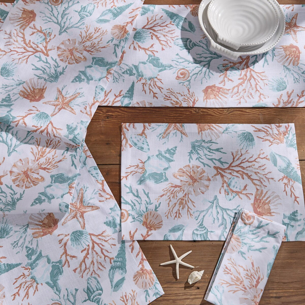 Seaside Treasures coastal table linens featuring coral, seashell, and starfish print with matching placemats, napkins, and table runner.