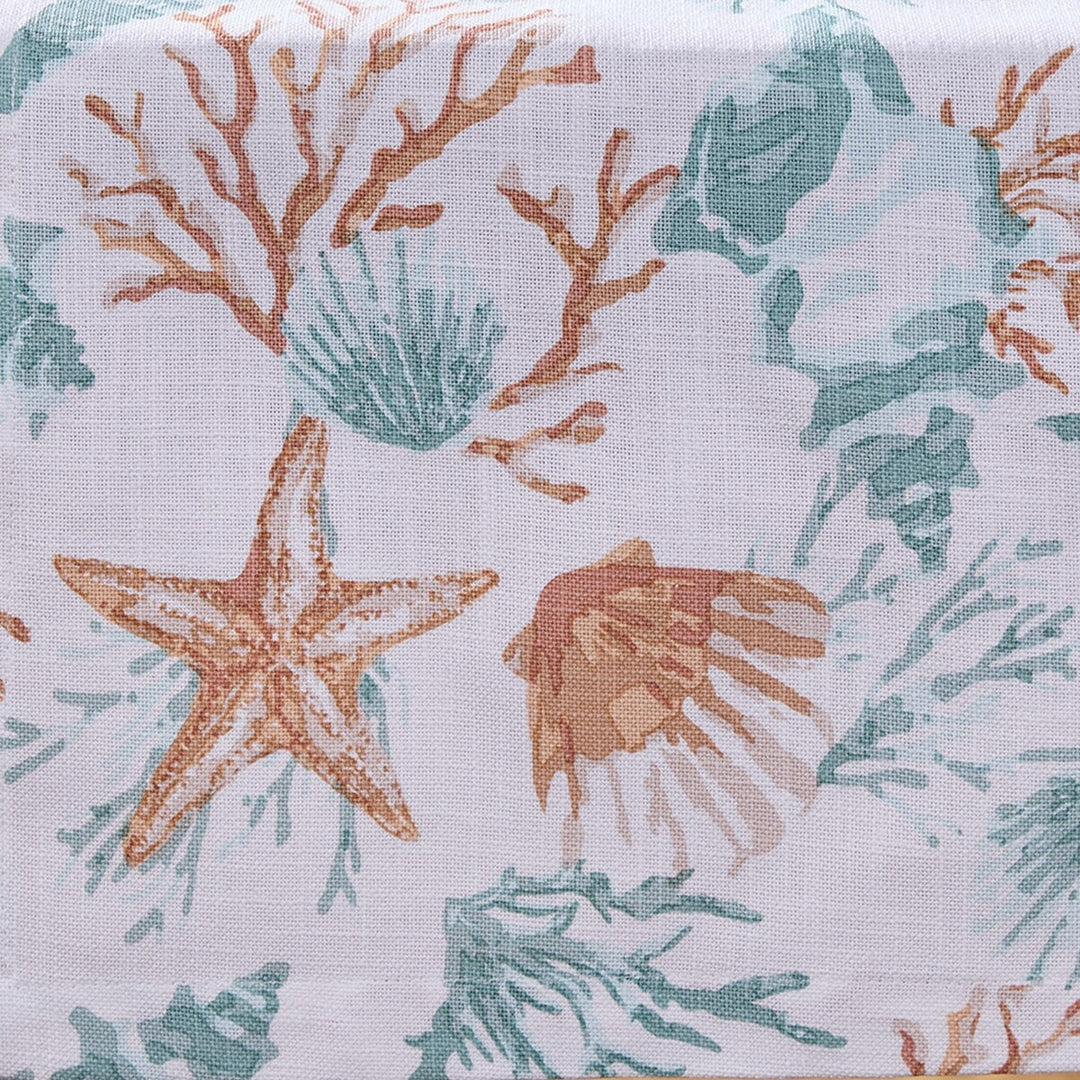 Close-up of the Seaside Treasures table runner featuring a coastal seashell, coral, and starfish print in soft aqua and coral hues.