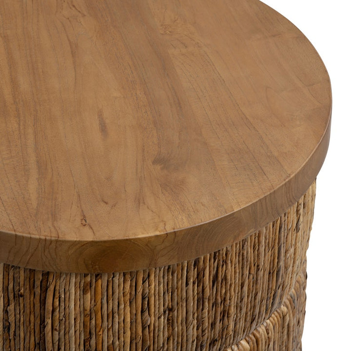Round wooden table with wicker base on a white background