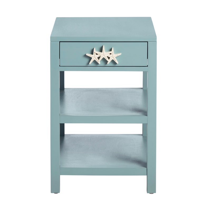 Blue side table with a drawer and starfish decor on a white background