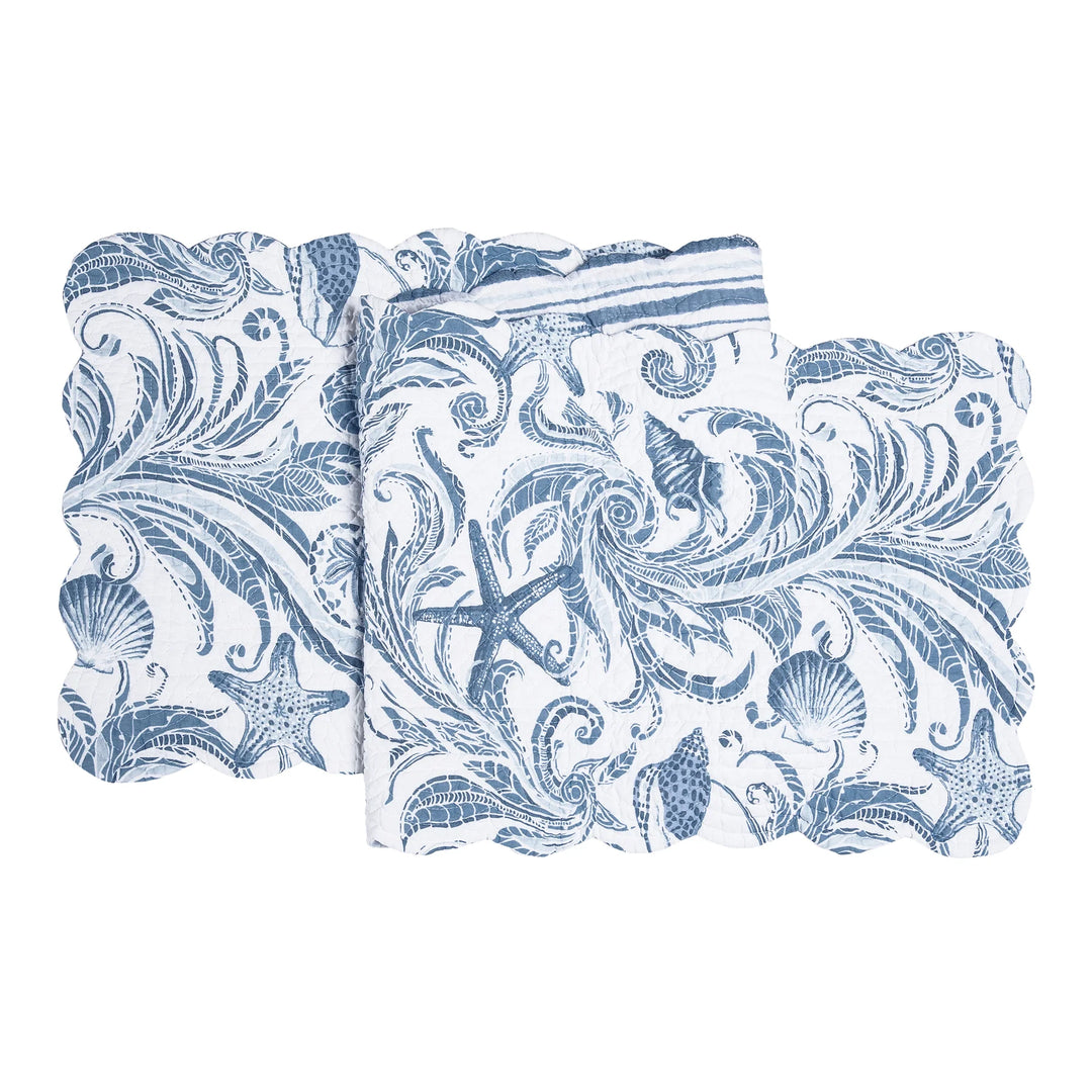Folded table runner with blue and white nautical pattern on a white background