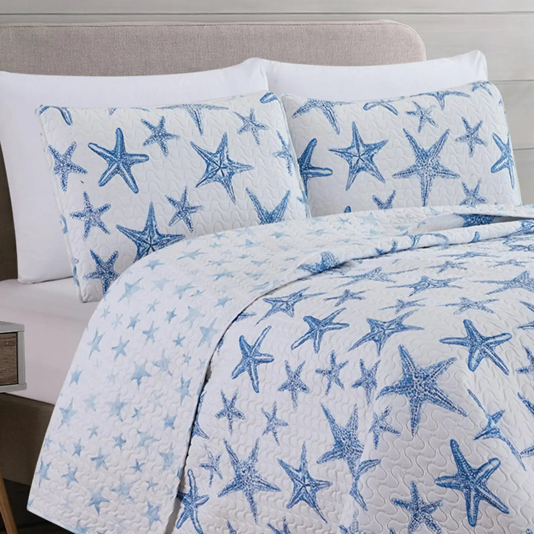Bedding set with blue starfish pattern on a white background