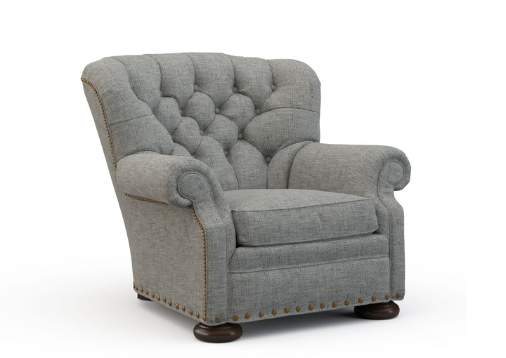 Gray upholstered armchair with tufted backrest on a white background