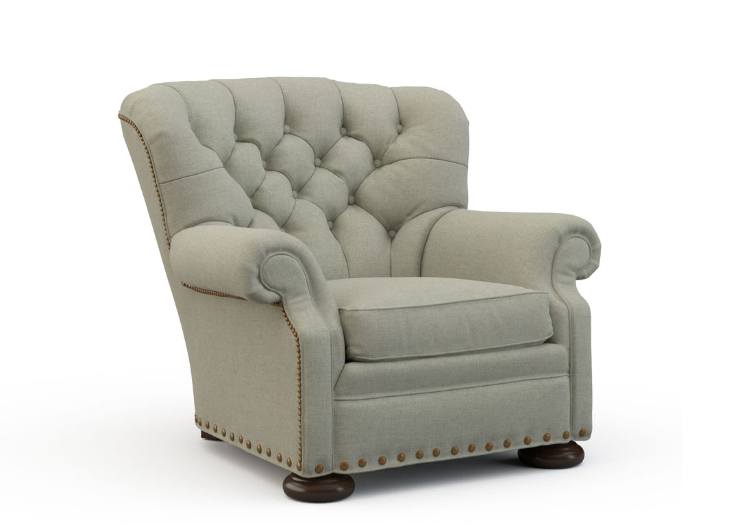 Light gray armchair with tufted backrest on a white background