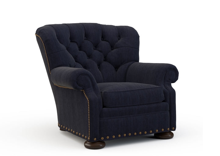Navy blue armchair with tufted backrest on a white background