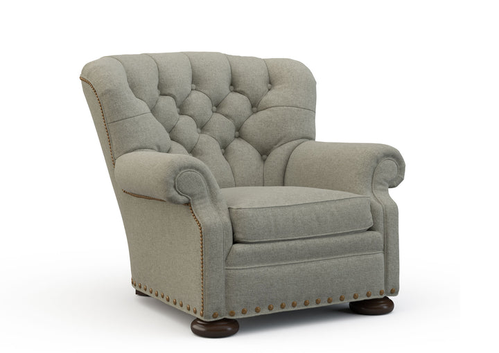 Gray armchair with tufted backrest on a white background