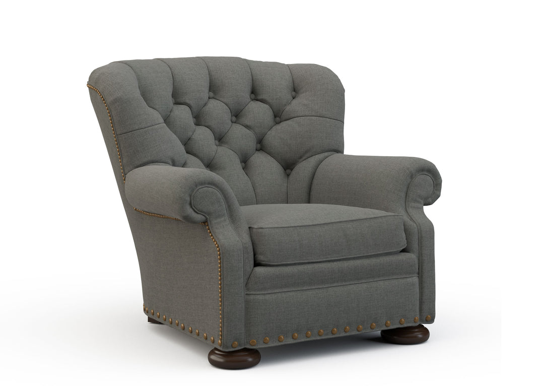 Gray armchair with tufted backrest on a white background