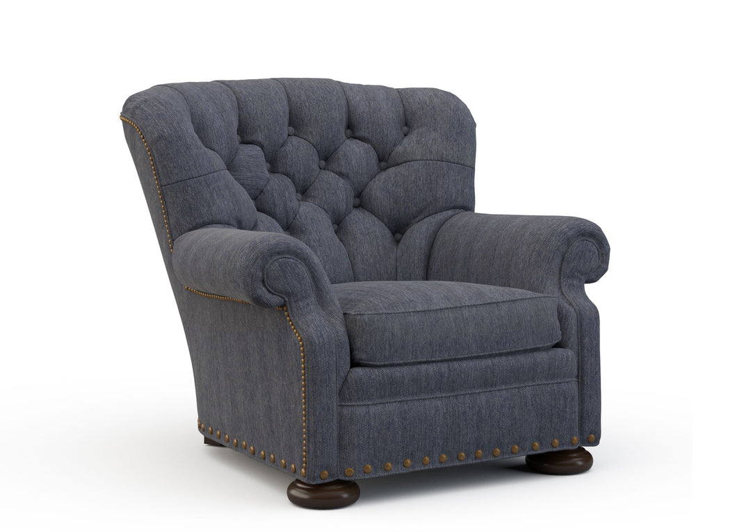 Blue armchair with tufted backrest on a white background