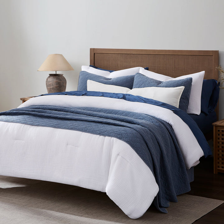 Voile Comforter Set in white paired with Blue cotton voile Blanket and pillow shams on a wooden bed