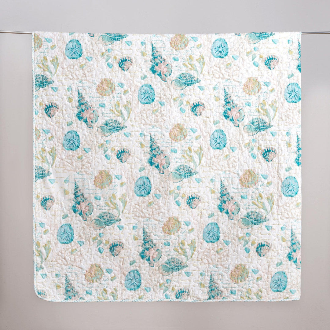 west sands quilt set hanging to dry on a gray background