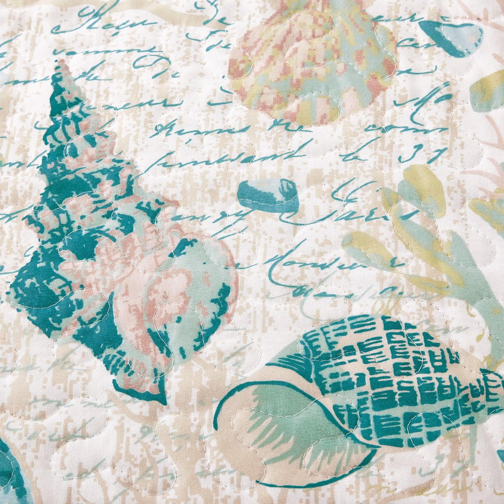 West Sands Quilt Pattern featuring blue, green and tan seashell motif pattern
