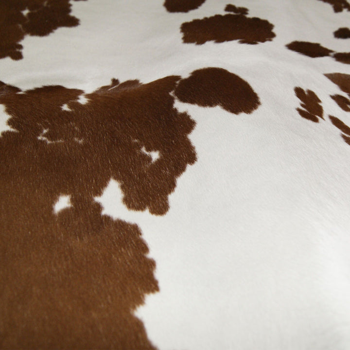 Brown and white cowhide detail - The Coastal Compass Home Decor