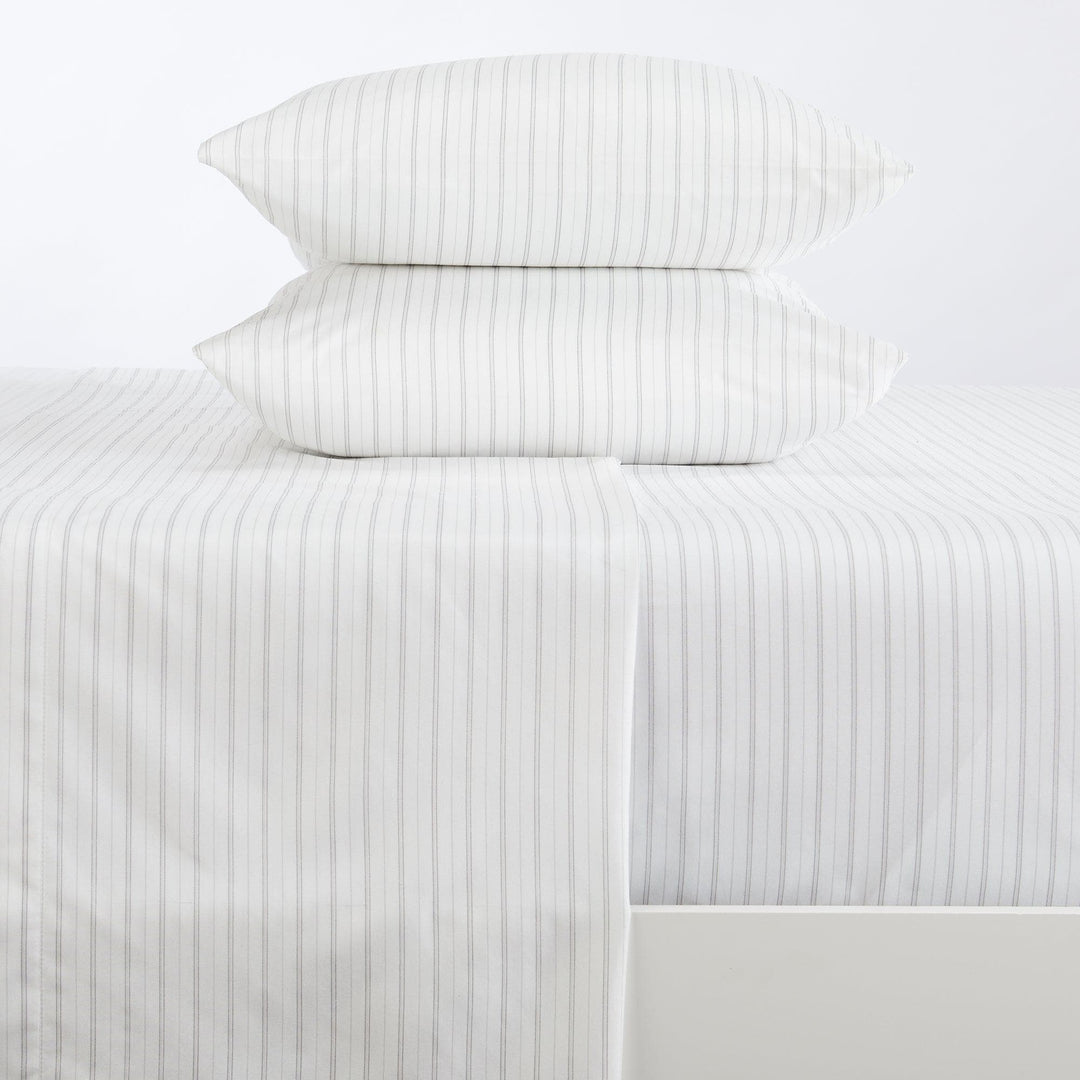 Striped bed sheets and pillowcases on a white background