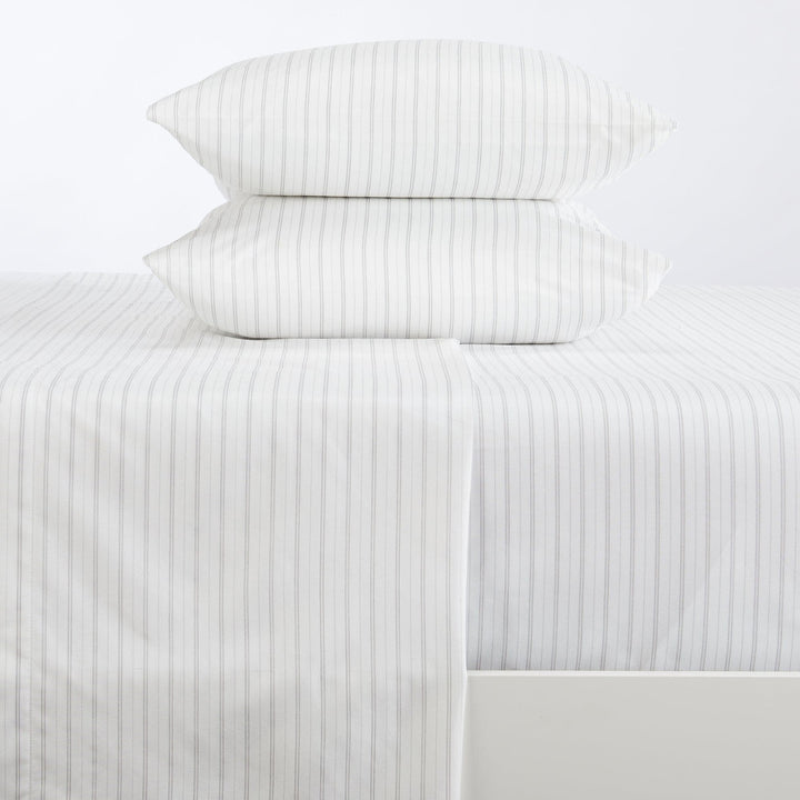 Striped bed sheets and pillowcases on a white background