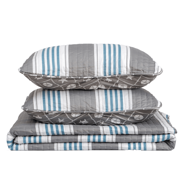 Stack of gray and blue striped bedding on a white background