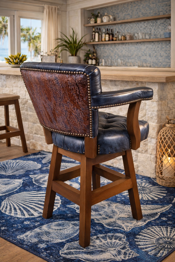 Nautical blue tufted leather swivel bar and counter stool in coastal bar with embossed cowhide back on blue sea shell area rug - American made