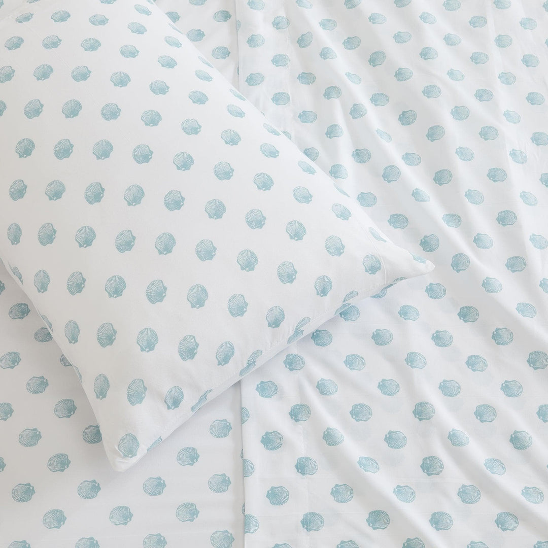 White fabric with light blue seashell pattern