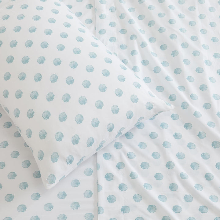 White fabric with light blue seashell pattern