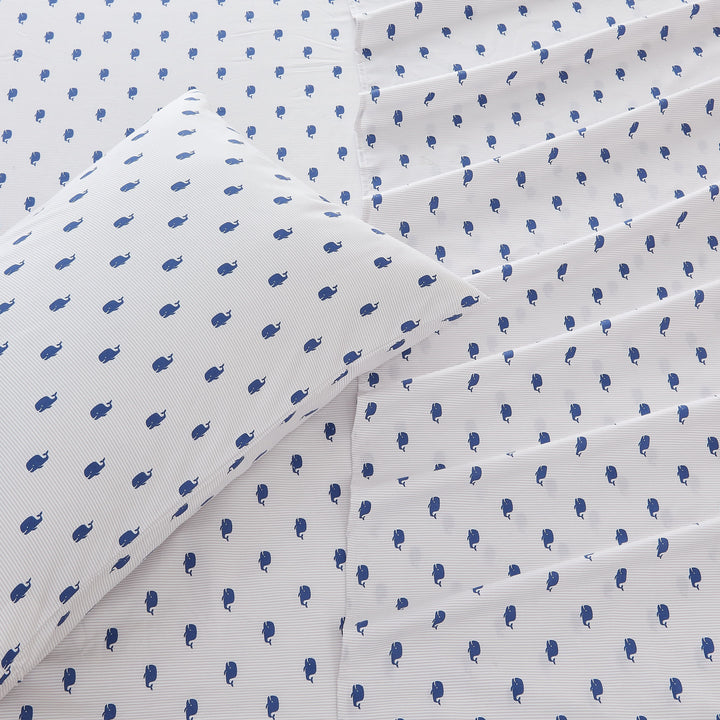 White fabric with small blue whale pattern, folded