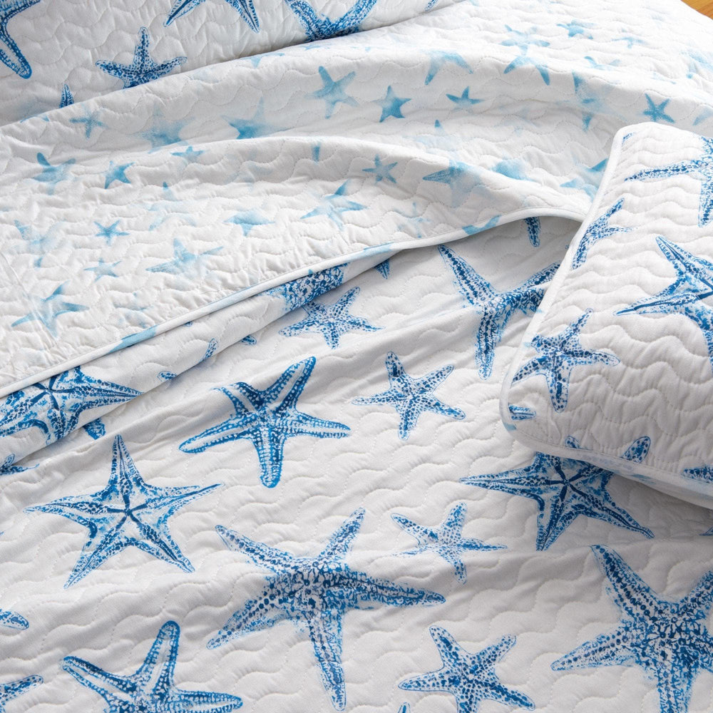 White quilt with blue starfish pattern