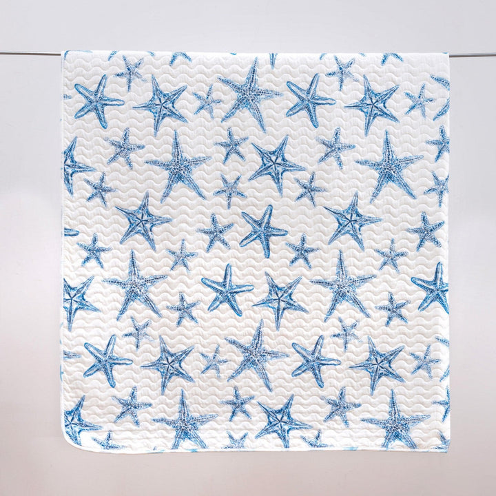 Patterned paper with blue starfish design on a white background