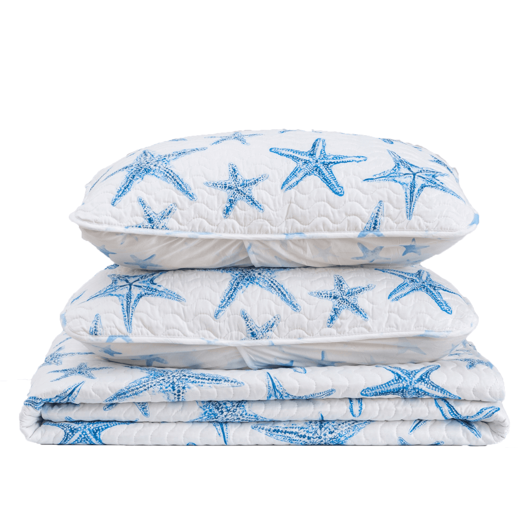 Stack of three quilted coverlets with blue starfish pattern on a white background