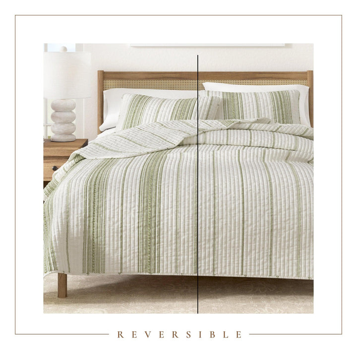 Green and white striped bedding set on a bed with a wooden headboard.