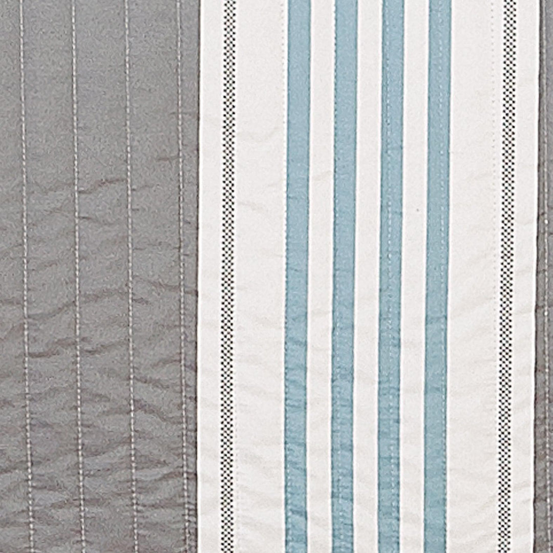 Striped fabric pattern with blue, gray, and white colors.