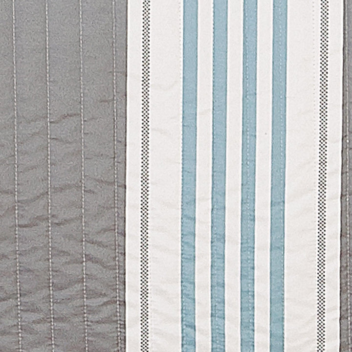 Striped fabric pattern with blue, gray, and white colors.