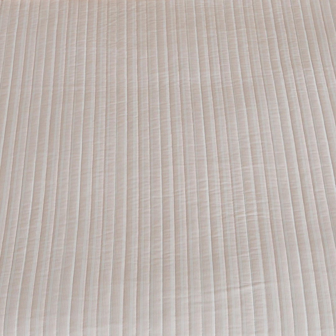 Close-up of striped mauve quilt