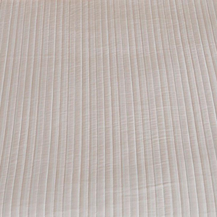 Close-up of striped mauve quilt