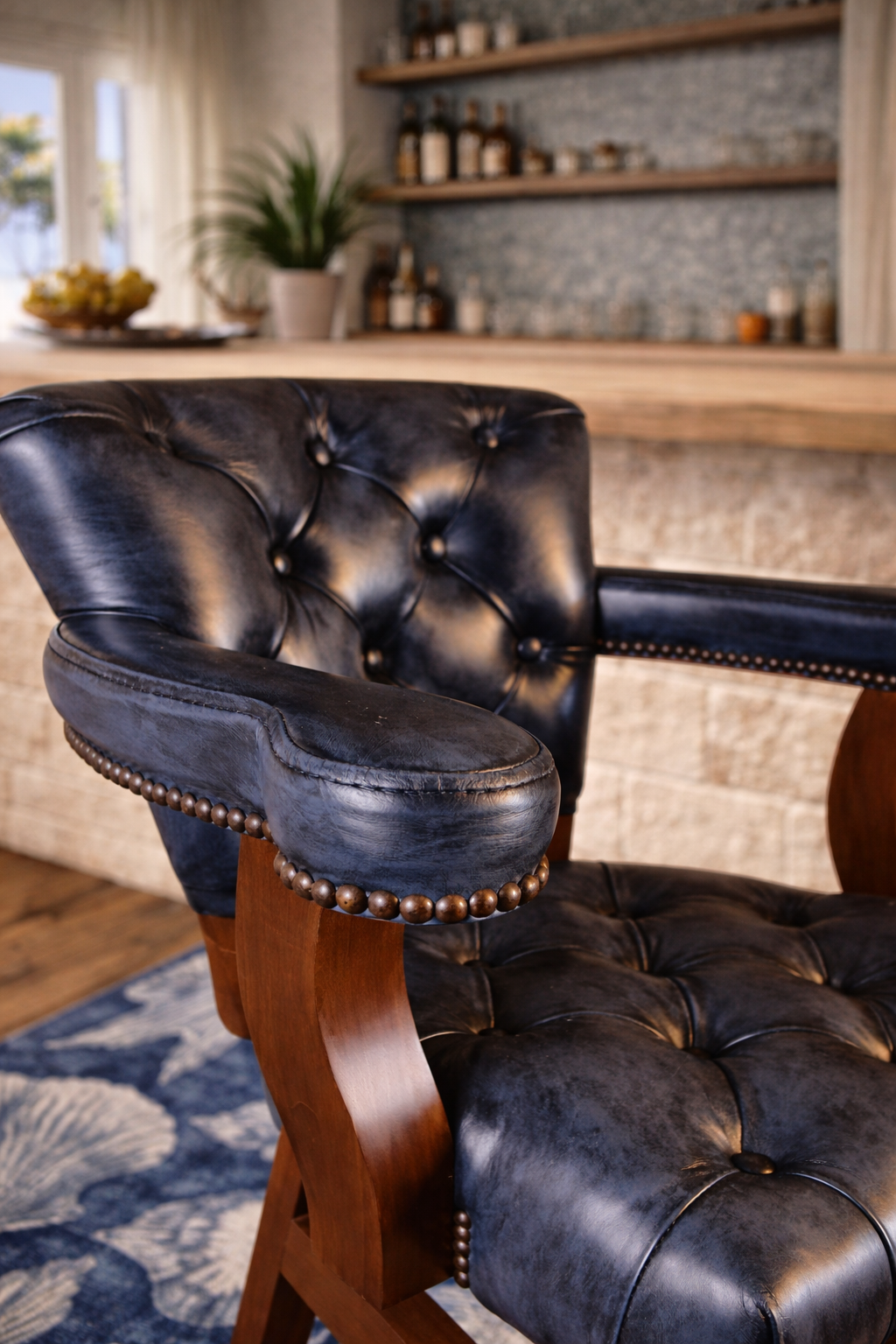 Nautical blue tufted leather swivel bar and counter stool are detail in coastal bar on blue sea shell area rug - American made
