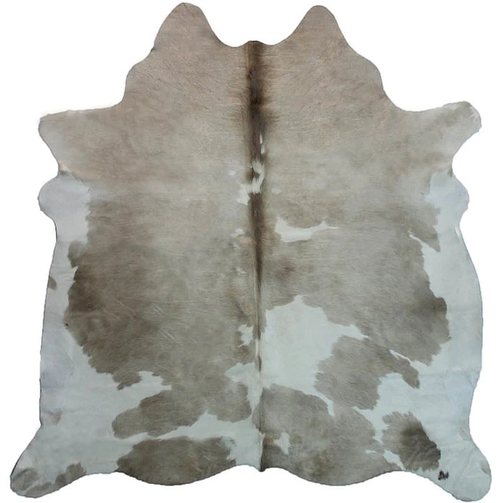 Taupe and white cowhide rug - The Coastal Compass Home Decor