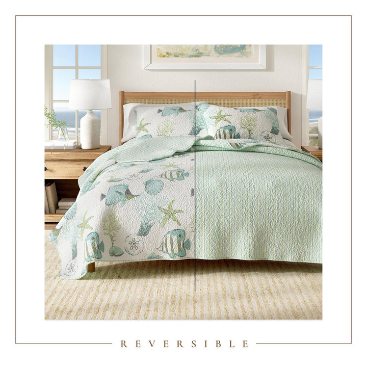 Reversible bedspread with ocean-themed design on a bed in a bedroom setting.