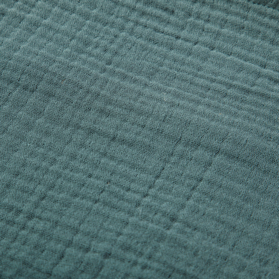 Close-up of voile cotton bedding in storm blue with a textured pattern