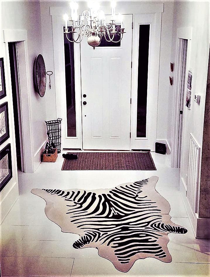 Stenciled zebra print on off-white cowhide- The Coastal Compass Home Decor