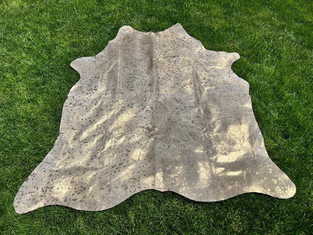 Metallic gold on beige cowhide rug - The Coastal Compass Home Decor